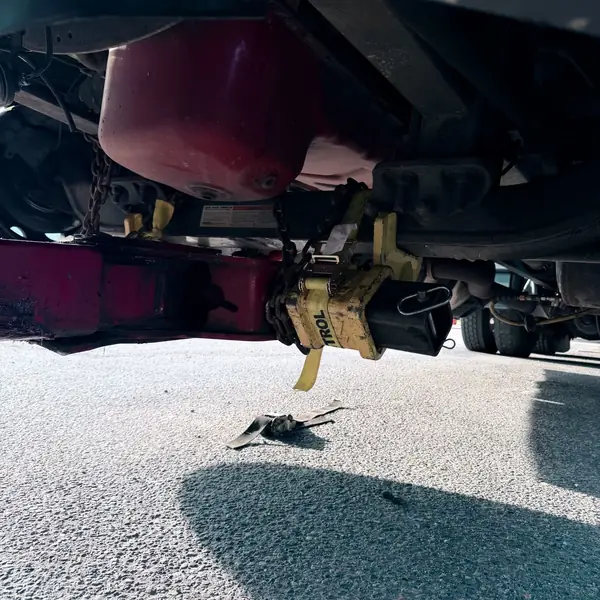 Close-up of underlift forks strapped to a truck axle
